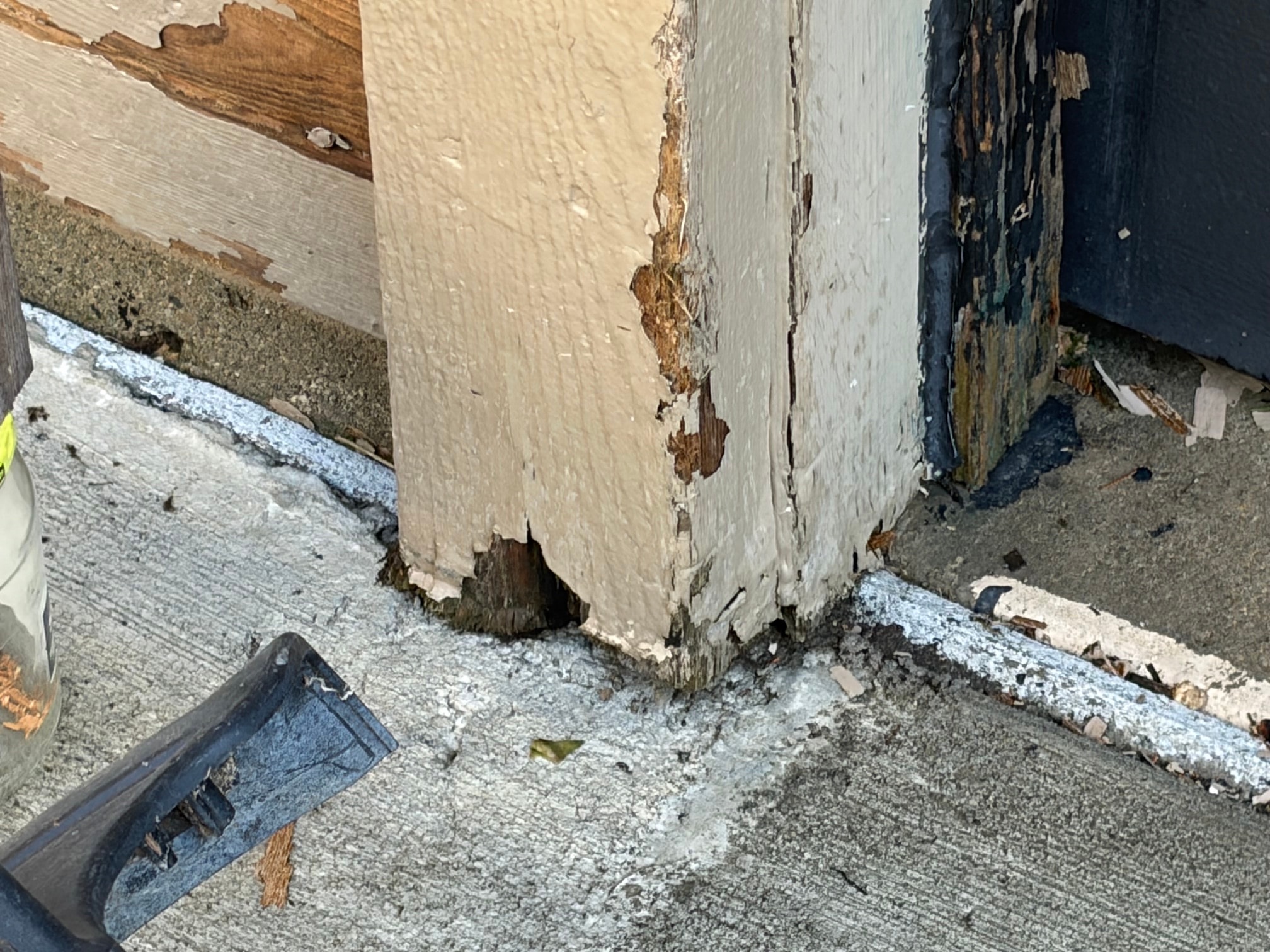 Rotted trim at the base of an exterior wall corner