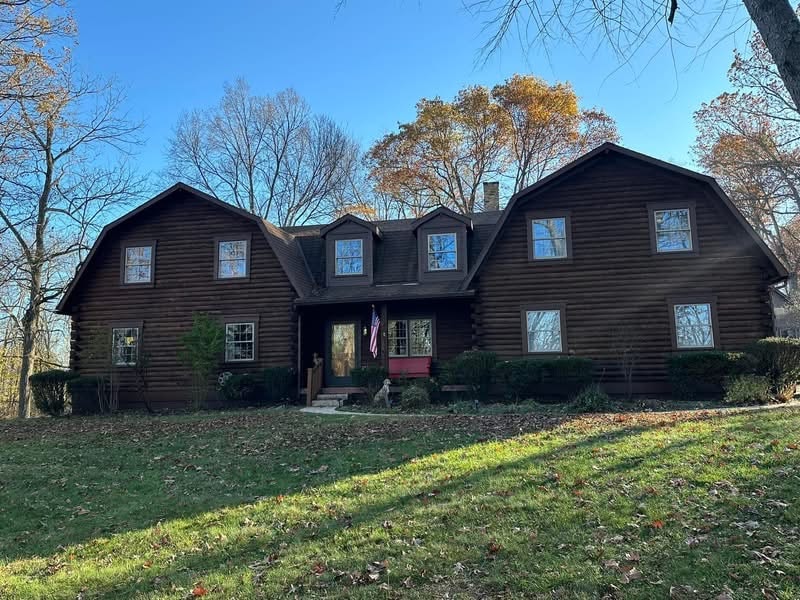 Professional painter working on beautiful home exterior